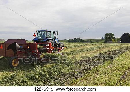 New Holland t5040 with H5430 windrow merger; New Holland, Pennsylvania, United States of America View Large Photo Image Stock Photography - New Holland t5040 with H5430 windrow merger; New Holland, Pennsylvania, United States of America. Fotosearch