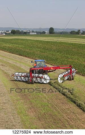 New Holland T5040 with H5980 wheel rake; New Holland, Pennsylvania, United States of America View Large Photo Image Picture - New Holland T5040 with H5980 wheel rake; New Holland, Pennsylvania, United States of America. Fotosearch