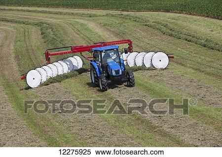 New Holland T5040 with H5980 wheel rake; New Holland, Pennsylvania, United States of America View Large Photo Image Stock Photography - New Holland T5040 with H5980 wheel rake; New Holland, Pennsylvania, United States of America. Fotosearch