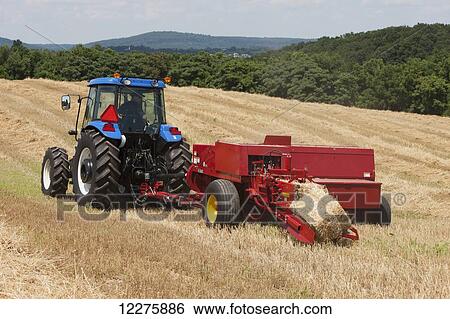 New Holland TD5050 with BC5070 square baler baling wheat straw for bedding; Lititz, Pennsylvania, United States of America View Large Photo Image Stock Photograph - New Holland TD5050 with BC5070 square baler baling wheat straw for bedding; Lititz, Pennsylvania, United States of America. Fotosearch
