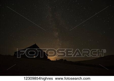 Night sky glowing over silhouette of a barn with a peaked roofline; Palouse, Washington, United States of America View Large Photo Image Stock Photograph - Night sky glowing over silhouette of a barn with a peaked roofline; Palouse, Washington, United States of America. Fotosearch