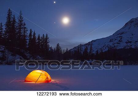Nighttime view of a lit tent on a snow covered Trail Lake with the moon, stars, and planets overhead, Moose Pass, Kenai Peninsula, Southcentral Alaska View Large Photo Image Stock Image - Nighttime view of a lit tent on a snow covered Trail Lake with the moon, stars, and planets overhead, Moose Pass, Kenai Peninsula, Southcentral Alaska. Fotosearch
