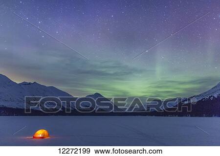 Nighttime view of a lit tent on a snow covered Trail Lake with the moon, stars, and Northern Lights overhead, Moose Pass, Kenai Peninsula, Southcentral Alaska View Large Photo Image Stock Photo - Nighttime view of a lit tent on a snow covered Trail Lake with the moon, stars, and Northern Lights overhead, Moose Pass, Kenai Peninsula, Southcentral Alaska. Fotosearch