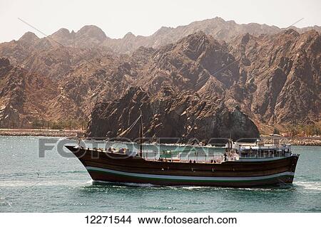 Picture - Ocean-going dhow, leaving Mutrah harbour; Muscat, Oman. Fotosearch