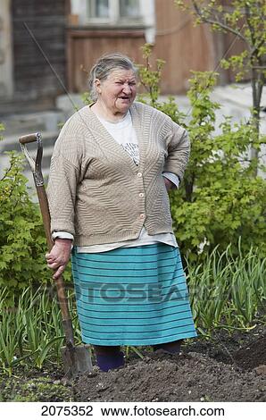 Old Woman In Her Garden In Trakai, Lithuania View Large Photo Image Stock Image - Old Woman In Her Garden In Trakai, Lithuania. Fotosearch