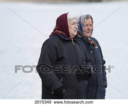 Stock Photo - Old Women Walking By The Shores On Lake Galve, Trakai, Lithuania. Fotosearch