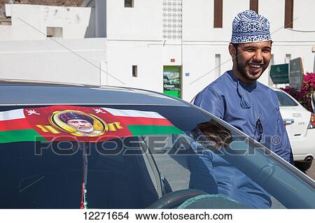 Omani man with Sultan Qaboos car sticker, Old Muscat; Muscat, Oman View Large Photo Image Picture - Omani man with Sultan Qaboos car sticker, Old Muscat; Muscat, Oman. Fotosearch