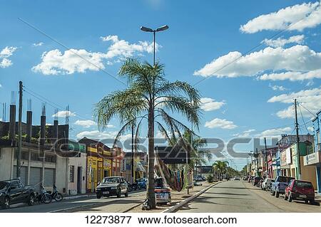 Stock Photo - Palm trees and colourful shops line the street in Jaguarao, the border between Brazil and Uruguay; Uruguay. Fotosearch