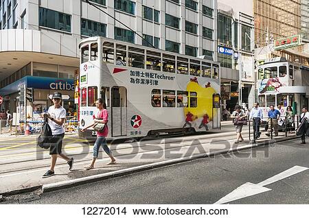 Passengers getting off the tram, Central District; Hong Kong, China View Large Photo Image Picture - Passengers getting off the tram, Central District; Hong Kong, China. Fotosearch