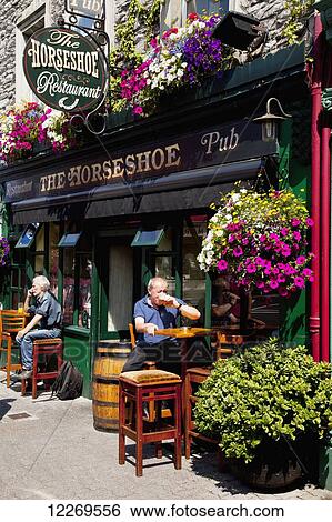 Stock Photograph - Patrons at the Horseshoe Pub; Kenmare, County Kerry, Ireland. Fotosearch