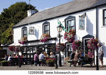Patrons sitting on an outdoor patio of an Inn; Schull, County Cork, Ireland View Large Photo Image Stock Photo - Patrons sitting on an outdoor patio of an Inn; Schull, County Cork, Ireland. Fotosearch