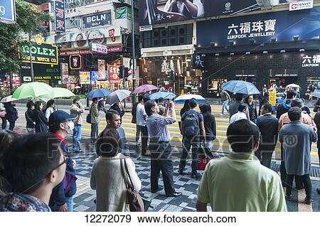 Pedestrians along Nathan Road in front of Chungking Mansions; Hong Kong, China View Large Photo Image Stock Photo - Pedestrians along Nathan Road in front of Chungking Mansions; Hong Kong, China. Fotosearch