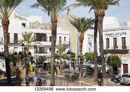 Stock Photo - Pedestrians in a town square; Vejer de la Frontera, Andalusia, Spain. Fotosearch