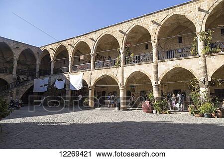 Pedestrians outside a building with columns and archways; Paphos, Cyprus View Large Photo Image Stock Image - Pedestrians outside a building with columns and archways; Paphos, Cyprus. Fotosearch