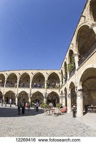Pedestrians outside a building with pillars and archways; Nicosia, Cyprus View Large Photo Image Stock Photograph - Pedestrians outside a building with pillars and archways; Nicosia, Cyprus. Fotosearch