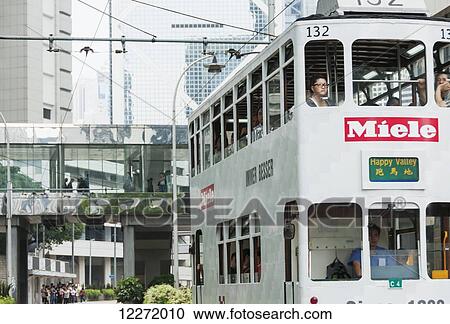 Pedestrians ride the tram and pedestrians in the gateway; Hong Kong, China View Large Photo Image Stock Image - Pedestrians ride the tram and pedestrians in the gateway; Hong Kong, China. Fotosearch