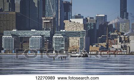 People and a boat on the ice against city skyline from Ward's Island; Toronto, Ontario, Canada View Large Photo Image Stock Photo - People and a boat on the ice against city skyline from Ward's Island; Toronto, Ontario, Canada. Fotosearch