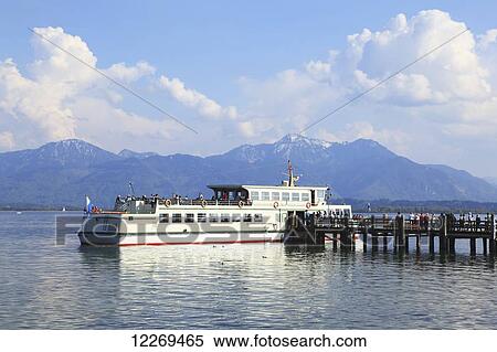 People board a ferry in a lake; Die Fraueninsel, Bayern, Germany View Large Photo Image Stock Photography - People board a ferry in a lake; Die Fraueninsel, Bayern, Germany. Fotosearch