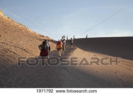 Stock Image - People Climbing A Sand Dune In The Valle De La Luna (Moon Valley), San Pedro De Atacama, Antofagasta Region, Chile. Fotosearch