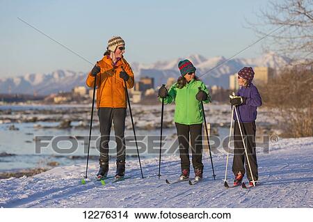 People cross country skiing on the Tony Knowles Coastal Trail near Earthquake Park with Anchorage skyline in the background, Cook Inlet, Southcentral Alaska View Large Photo Image Picture - People cross country skiing on the Tony Knowles Coastal Trail near Earthquake Park with Anchorage skyline in the background, Cook Inlet, Southcentral Alaska. Fotosearch