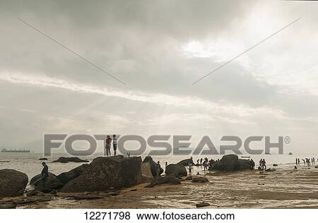 Stock Photo - People enjoying the seaside; Xiamen, Fujian province, China. Fotosearch