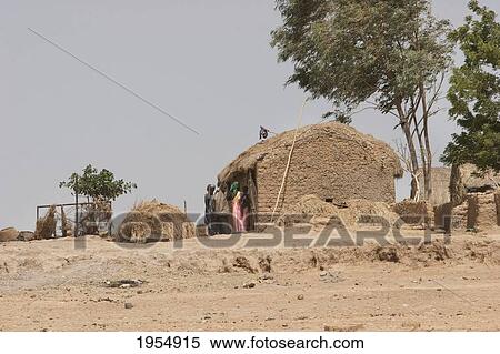 Stock Photography - People in front of the mud houses along the shores of the Niger River between Mopti and Lake Debo, Mali. Fotosearch