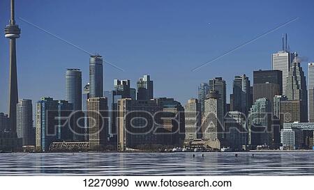 People in the distance on the ice against city skyline from Ward's Island; Toronto, Ontario, Canada View Large Photo Image Stock Image - People in the distance on the ice against city skyline from Ward's Island; Toronto, Ontario, Canada. Fotosearch