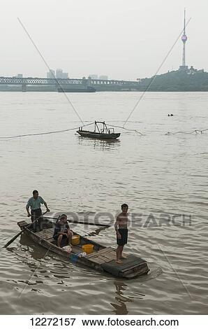 Stock Photo - People on a small boat on the Yangtze river; Wuhan, Hubei province, China. Fotosearch