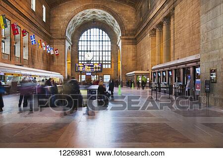 Stock Image - People rushing through Union Station; Toronto, Ontario, Canada. Fotosearch