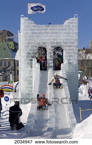 Stock Photo - People Sliding Down Ice Slide, Quebec Winter Carnival, Plains Of Abraham, Quebec City, Quebec. Fotosearch