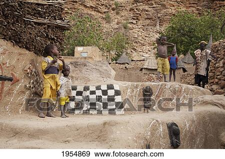 Stock Photo - People standing by the Toguna (House of words) in Tireli, Mali. Fotosearch