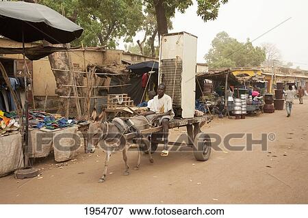 Stock Photo - People transporting a refrigerator on a donkey cart in Segou, Mali. Fotosearch