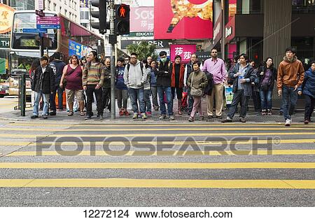 People waiting for the green light to cross Nathan Road, Kowloon; Hong Kong, China View Large Photo Image Picture - People waiting for the green light to cross Nathan Road, Kowloon; Hong Kong, China. Fotosearch
