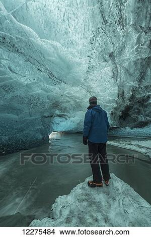 Picture - Person standing under the Vatnajorkull ice cap; Iceland. Fotosearch