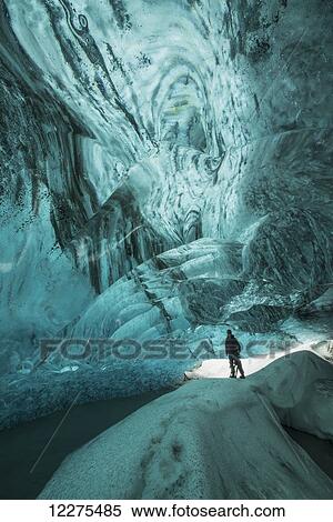 Person standing under the Vatnajorkull ice cap in a large ice cave; Iceland View Large Photo Image Stock Photography - Person standing under the Vatnajorkull ice cap in a large ice cave; Iceland. Fotosearch