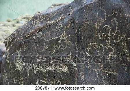 Stock Image - Petroglyphs On A Boulder Show A Large Of Number Of Sogdian And Brahmi Inscriptions, Along With A Phallus, Shatial Near Chilas, Northern Areas, Pakistan. Fotosearch