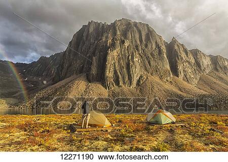 Photographer taking pictures of the late afternoon light hitting Talus Lake in the Tombstone Territorial Park of the northern Yukon; Yukon, Canada View Large Photo Image Stock Image - Photographer taking pictures of the late afternoon light hitting Talus Lake in the Tombstone Territorial Park of the northern Yukon; Yukon, Canada. Fotosearch