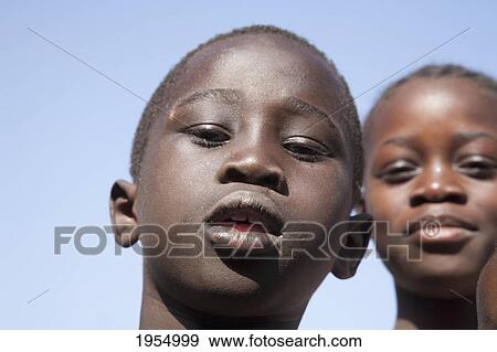 Portrait of a boy with friend against sky in Bamako, Mali View Large Photo Image Stock Photo - Portrait of a boy with friend against sky in Bamako, Mali. Fotosearch