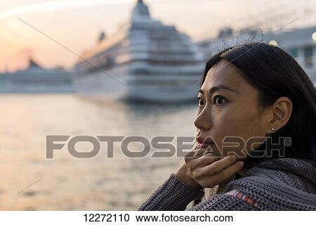 Portrait of a young woman at the waterfront with cruise ships in the harbour in the background, Kowloon; Hong Kong, China View Large Photo Image Stock Image - Portrait of a young woman at the waterfront with cruise ships in the harbour in the background, Kowloon; Hong Kong, China. Fotosearch