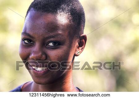 Stock Photograph - Portrait of an African woman smiling; South Africa. Fotosearch