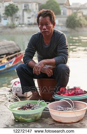 Portrait of fisherman in the traditional Shapowei; Xiamen, Fujian Province, China View Large Photo Image Stock Photo - Portrait of fisherman in the traditional Shapowei; Xiamen, Fujian Province, China. Fotosearch