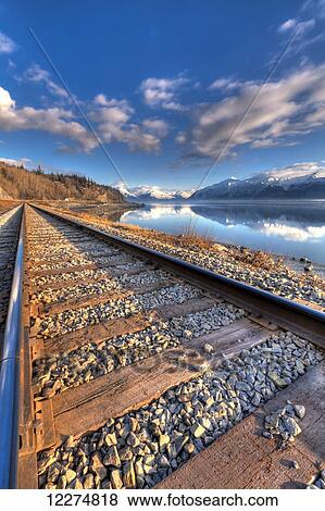 Stock Photo - Railroad tracks along Turnagain Arm and the Seward Highway near Anchorage, Southcentral Alaska, Spring, HDR. Fotosearch