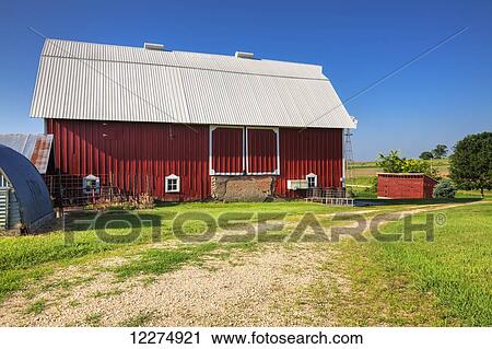 Stock Image - Red barn on a farm in Clayton County; Iowa, United States of America. Fotosearch