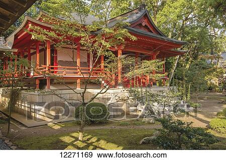 Stock Photo - Red Japanese temple building and garden; Arashiyama, Kyoto, Japan. Fotosearch