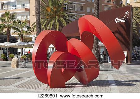 Stock Image - Red sculpture in an urban area; Conil de la Frontera, Andalusia, Spain. Fotosearch