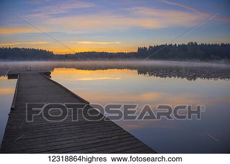 Reflection of a beautiful serene sunrise on peaceful Scott lake; Washington, United States of America View Large Photo Image Stock Photograph - Reflection of a beautiful serene sunrise on peaceful Scott lake; Washington, United States of America. Fotosearch