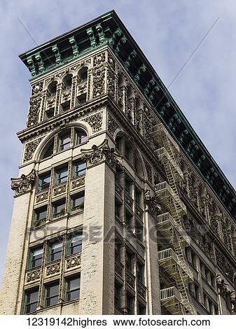 Residential building with ornate facade and fire escapes in lower Manhattan, Soho; New York City, New York, United States of America View Large Photo Image Stock Photograph - Residential building with ornate facade and fire escapes in lower Manhattan, Soho; New York City, New York, United States of America. Fotosearch