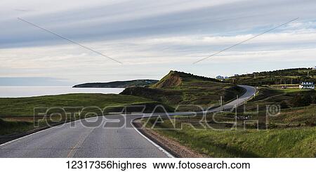 Stock Photograph - Road along the Atlantic coastline, Cape Breton Island; Belle Cote, Nova Scotia, Canada. Fotosearch