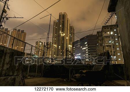 Rooftop of an old apartment with a view of other residential buildings at dusk; Hong Kong, China View Large Photo Image Stock Image - Rooftop of an old apartment with a view of other residential buildings at dusk; Hong Kong, China. Fotosearch