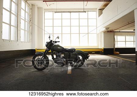 Royal Enfield Cafe Cruiser in parking garage; Toronto, Ontario, Canada View Large Photo Image Stock Photograph - Royal Enfield Cafe Cruiser in parking garage; Toronto, Ontario, Canada. Fotosearch